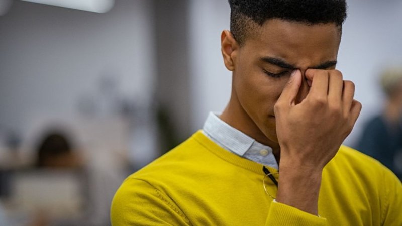 Homem com enxaqueca ocular