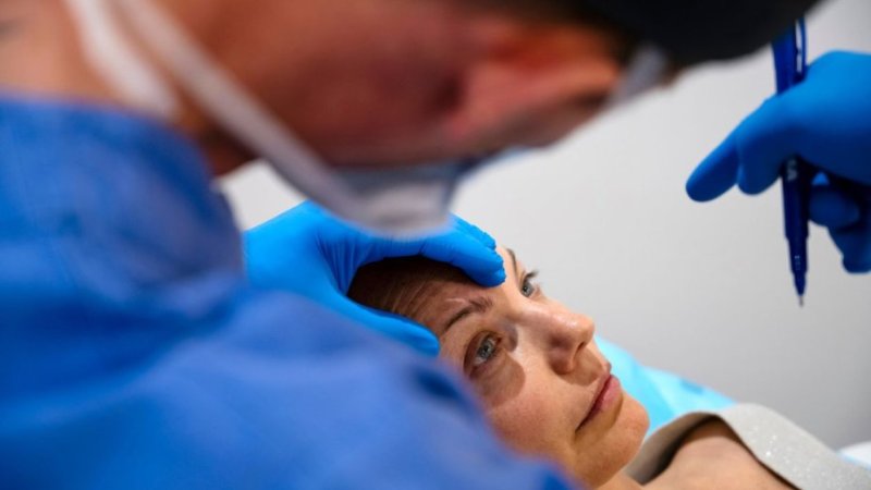 Mulher em consulta com médico cirurgião para realização de blefaroplastia