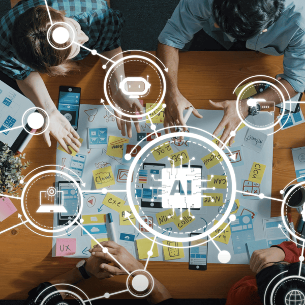 trabalho em equipa numa mesa com ferramentas de Inteligência Artificial